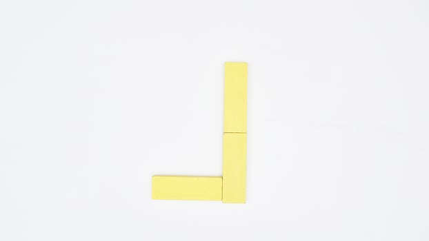 Letter J from yellow color wood block isolated on white background photo