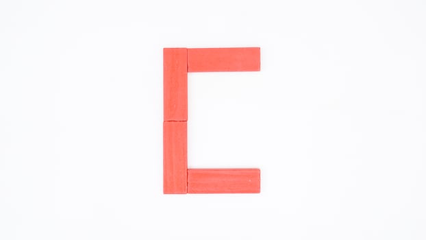 Letter C from red color wood block isolated on white background photo