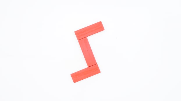 Isolated letter S from red color wood block on white background photo