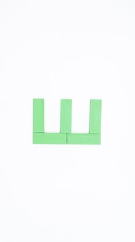 Letter E from green color wood block isolated on white background photo