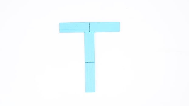 Letter T from blue color wood block isolated on white background photo