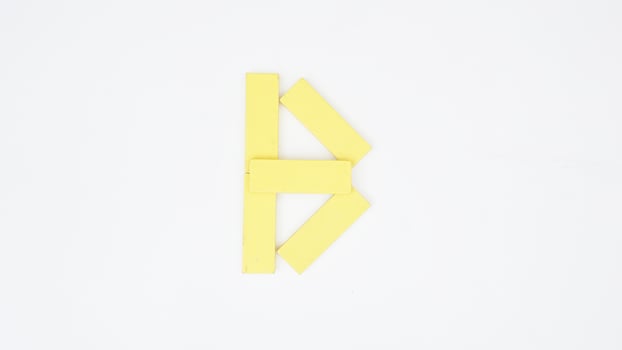 Letter B from yellow color wood block isolated on white background photo