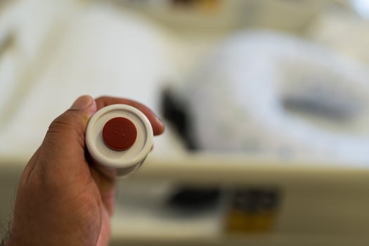 Hand holding an emergency nurse call button. photo