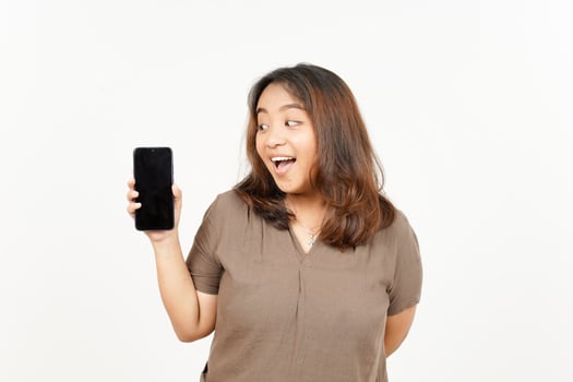 Asian woman holding a cell phone and looking surprised photo