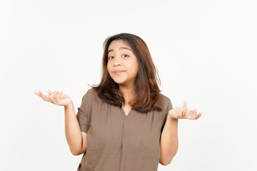 A woman is holding up her hands and looking confused photo