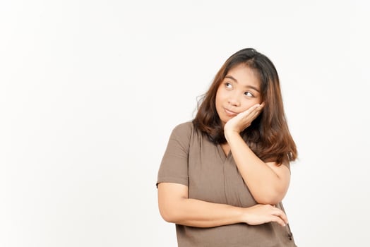 A woman is standing with her hand on her chin photo