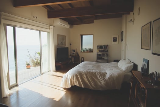 A bedroom with a bed and a sliding glass door photo