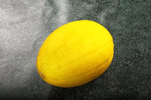 A yellow fruit on a table photo