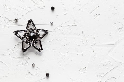 White background with handmade brooch black star photo