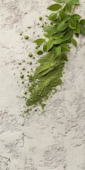 Moringa powder and fresh leaves on a textured surface photo