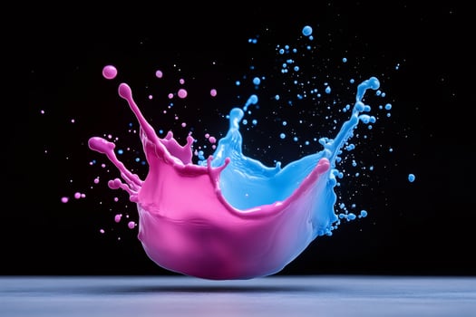 Pink and blue paint splashing together on black background photo