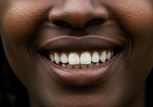 A close-up of a woman's radiant smile showcases healthy teeth and glossy lips. photo