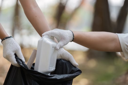 Teamwork in action. volunteers disposing of waste during a park cleanup photo