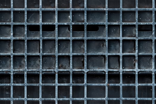 A close up of a metal grate with holes photo