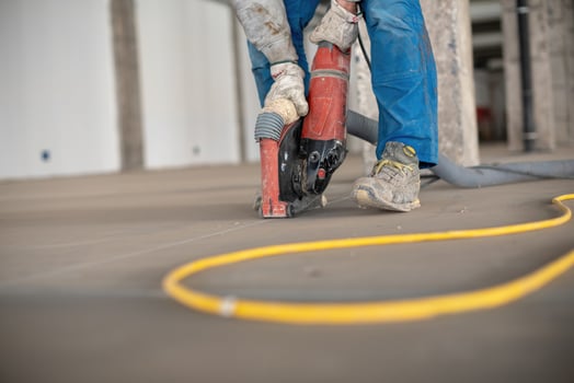 Crop site worker using concrete cutter photo