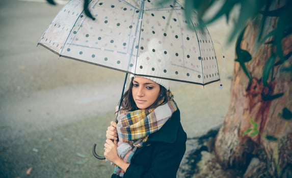 A woman is holding an umbrella in the rain. photo