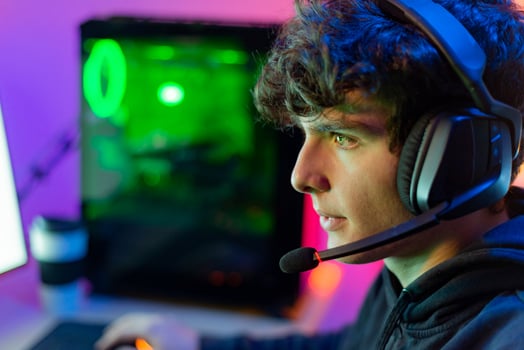 Man with gaming headset playing computer game photo