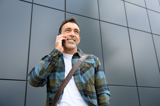 Cheerful young man talking on smartphone photo