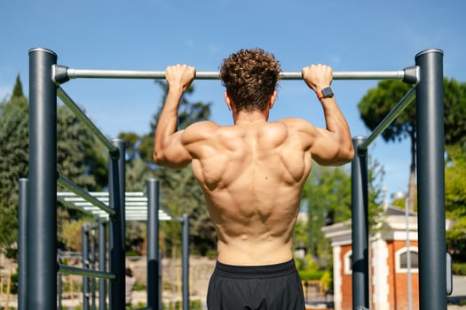 Strong young sportsman doing calisthenics photo