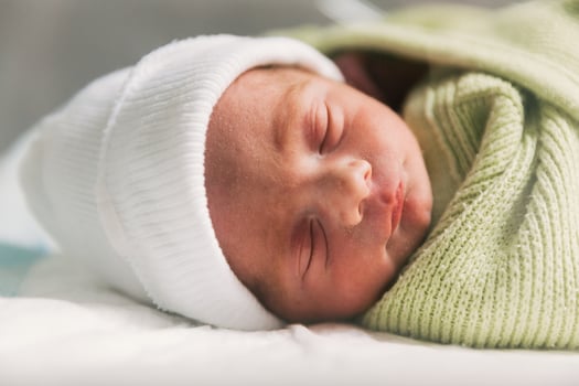 Newborn baby sleeping in crib. Babyhood concept. photo