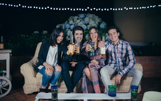 Happy friends drinking and having fun in a party photo