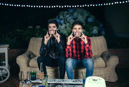 Funny men holding smartphones showing female mouths smiling photo