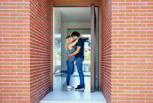 A man and woman are standing in front of a brick wall photo
