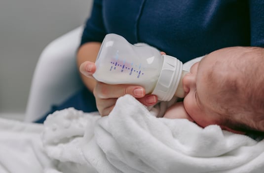 Baby detail taking feeding bottle photo