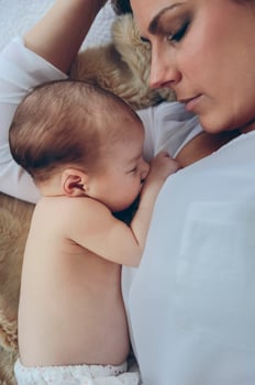 Mother hugging her newborn baby girl photo