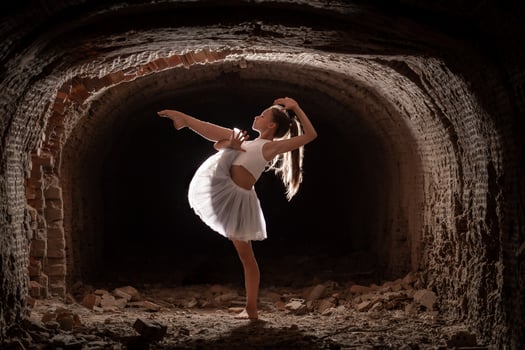 Young girl performing rhythmic gymnastics exercises outdoors photo