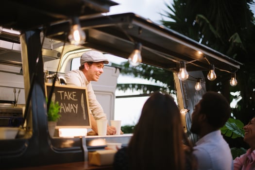 Happy vendor communicating with customers photo