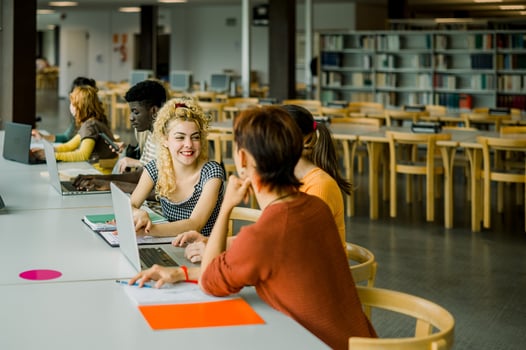 Group of multiethnic students sitting in library photo