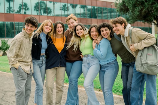 Group of cheerful diverse friends standing on road photo