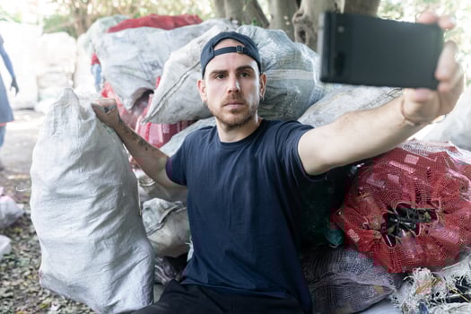 Young Caucasian Man Taking Selfie with Recycled Materials photo