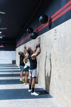 Hispanic sportspeople training with medical balls photo