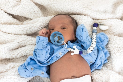 Newborn baby on soft blanket photo