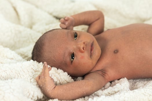 Newborn baby on soft blanket photo