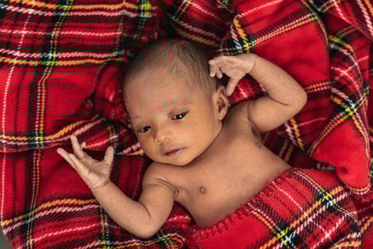 Newborn baby on soft tartan blanket photo