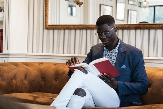 Pensive black businessman reading book in cafe photo