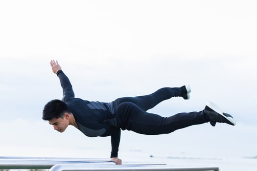 Athlete doing exercise on parallel bars. photo