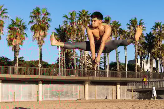 Strong man jumping high during outdoor workout. photo