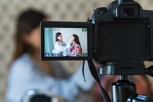 A woman is taking a photo of herself on a camera
