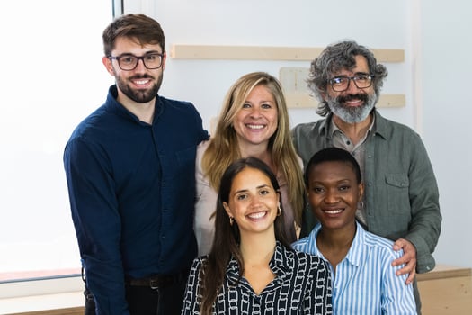 A group of multiracial employees standing together in an office photo