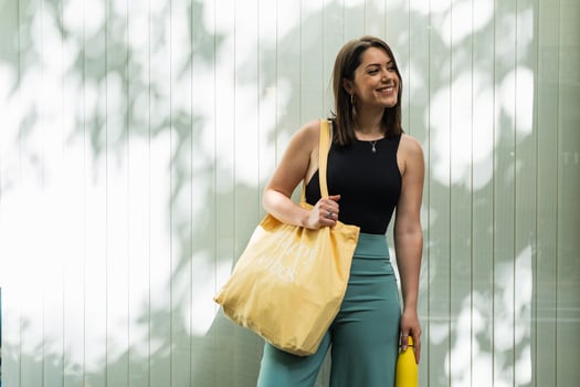 A woman holding a yellow shopping bag photo