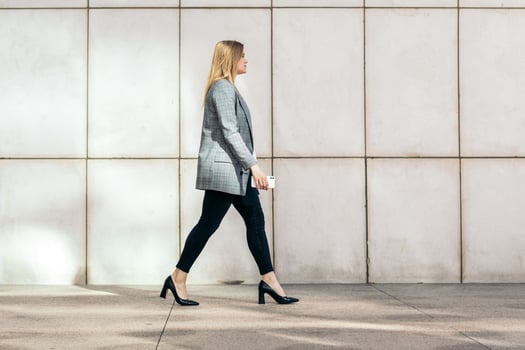 Side view of a businesswoman in a suit and heels on her way to the office photo