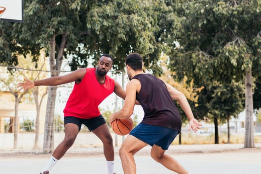 Two men playing basketball on a court photo