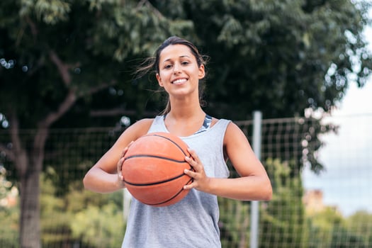 A woman holding a basketball in her hands photo