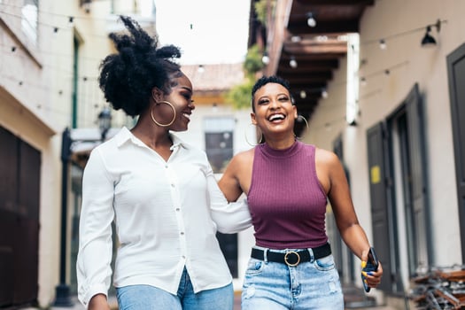 African american women laughing and having fun walking in the city. photo