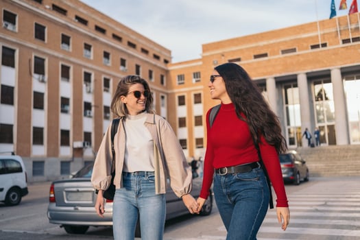 lesbian student couple in college holding hands photo