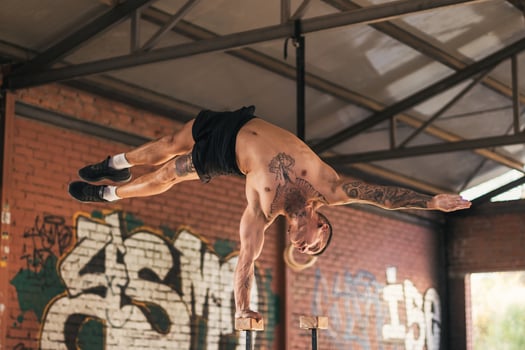 male athlete doing one hand handstand photo